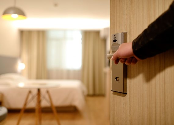 man opening an entrance for a hotel room