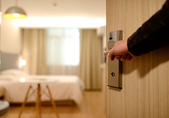 man opening an entrance for a hotel room